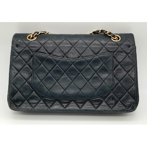 39 - A Classic Chanel Vintage Flap Bag. Calf skin midnight blue quilted leather. Gilded hardware. Black a... 