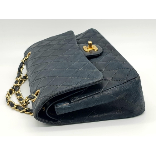 39 - A Classic Chanel Vintage Flap Bag. Calf skin midnight blue quilted leather. Gilded hardware. Black a... 