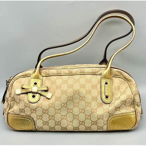 46 - A Gucci Canvas Princy Shoulder Bag. A canvas body with gilded leather trim. Interior zipped compartm... 