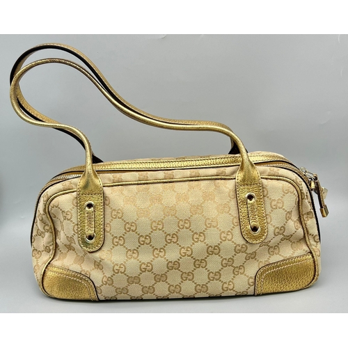 46 - A Gucci Canvas Princy Shoulder Bag. A canvas body with gilded leather trim. Interior zipped compartm... 