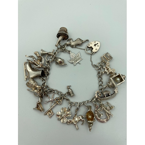 196 - Vintage SILVER CHARM BRACELET Complete with 22 silver charms to include Horse, lamp, gondola, Ice sk... 