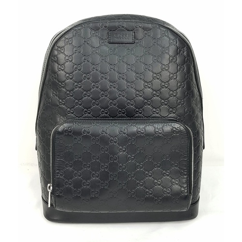 186 - A Gucci Signature GG Black Leather Backpack. Outer zipped compartment. Roomy interior with clip flap... 