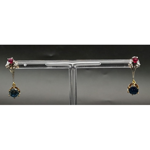 998 - A Pair of dangler earrings with 1ct each of natural sapphires, diamonds and rubies. Set in white met... 