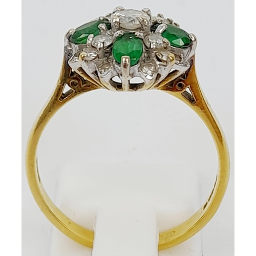 102 - An 18K Yellow Gold Emerald and Diamond Decorative Floral Ring. Quality stones in an attractive forma... 