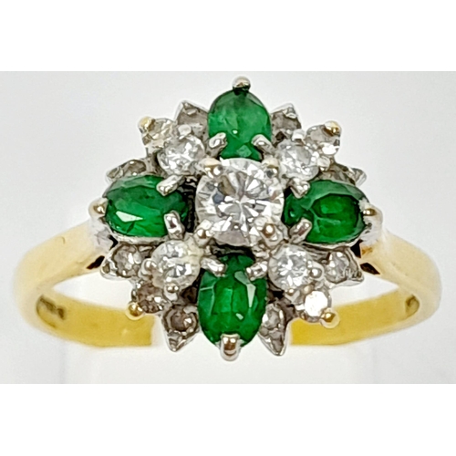 102 - An 18K Yellow Gold Emerald and Diamond Decorative Floral Ring. Quality stones in an attractive forma... 