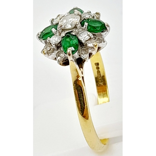 102 - An 18K Yellow Gold Emerald and Diamond Decorative Floral Ring. Quality stones in an attractive forma... 