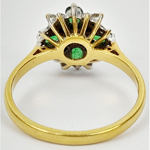 102 - An 18K Yellow Gold Emerald and Diamond Decorative Floral Ring. Quality stones in an attractive forma... 