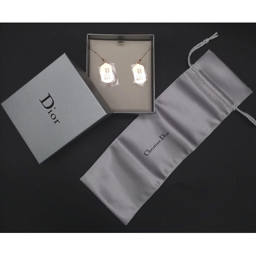 124 - A Pair of Christian Dior Gilded Tag Earrings. Comes with a silver tone pouch and box. Excellent cond... 