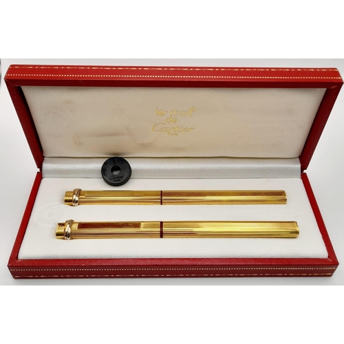 132 - Two Must de Cartier Gold Plated Pens in a Cartier Case. A fountain pen and a Ballpoint pen. Both 14c... 