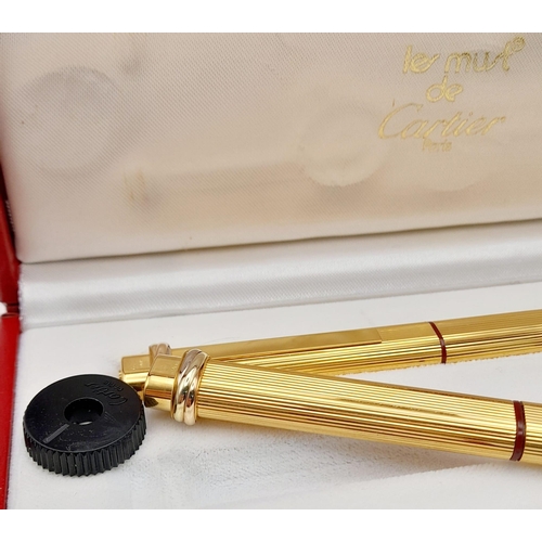 132 - Two Must de Cartier Gold Plated Pens in a Cartier Case. A fountain pen and a Ballpoint pen. Both 14c... 