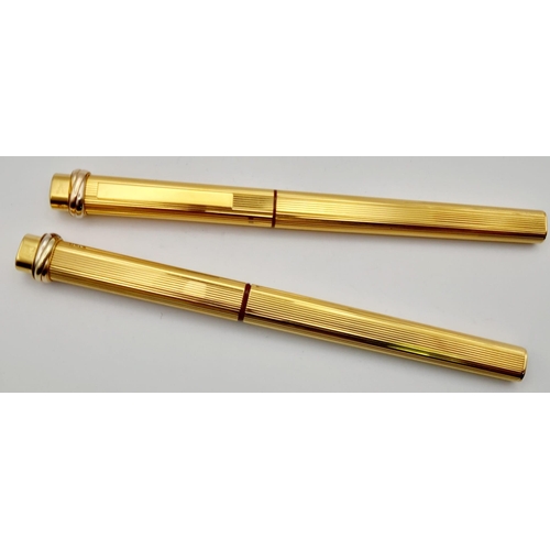 132 - Two Must de Cartier Gold Plated Pens in a Cartier Case. A fountain pen and a Ballpoint pen. Both 14c... 