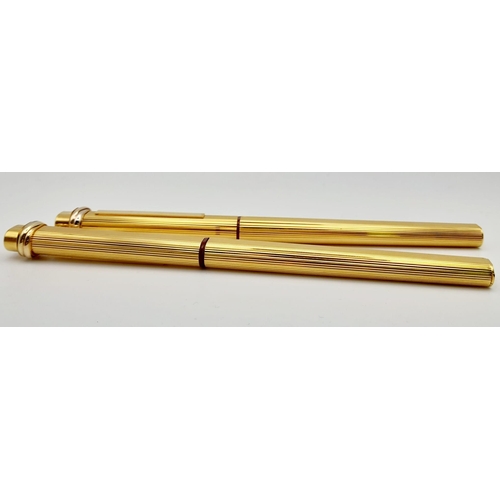 132 - Two Must de Cartier Gold Plated Pens in a Cartier Case. A fountain pen and a Ballpoint pen. Both 14c... 