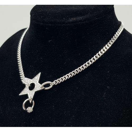 139 - A Christian Dior White Metal Star Necklace. 36cm. Comes with a Dior case. Ref: 11950