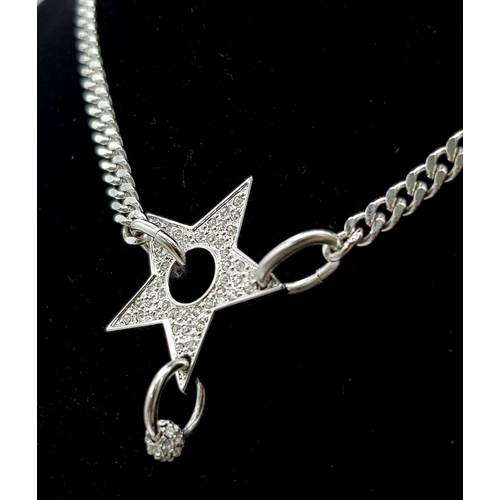 139 - A Christian Dior White Metal Star Necklace. 36cm. Comes with a Dior case. Ref: 11950