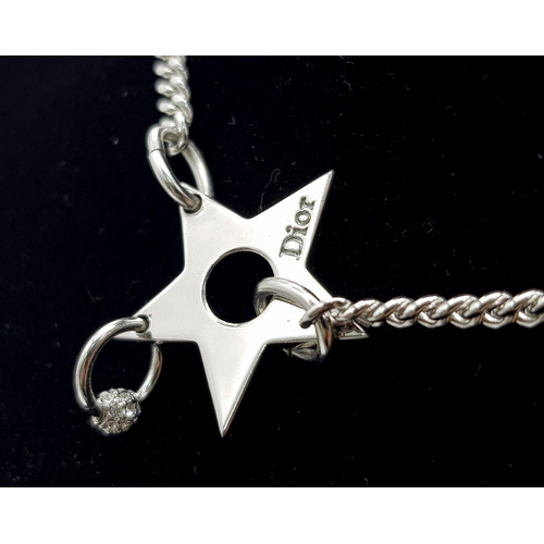 139 - A Christian Dior White Metal Star Necklace. 36cm. Comes with a Dior case. Ref: 11950