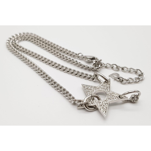 139 - A Christian Dior White Metal Star Necklace. 36cm. Comes with a Dior case. Ref: 11950