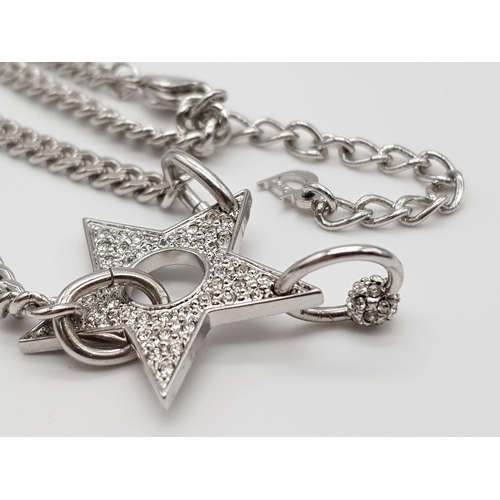 139 - A Christian Dior White Metal Star Necklace. 36cm. Comes with a Dior case. Ref: 11950