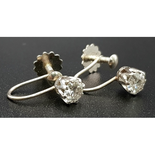 122 - A Pair of 18K Gold and Diamond Earrings. Bright white round cut diamonds - 0.50ct total. Screw-fit c... 