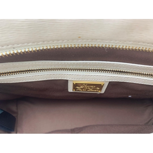 2 - A Ralph Lauren Cream Leather Handbag. Two exterior flaps. Zipped inner compartment. 36cm width. 26cm... 