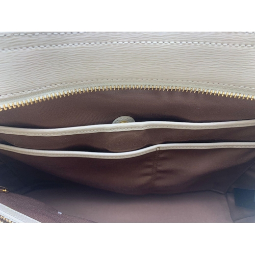 2 - A Ralph Lauren Cream Leather Handbag. Two exterior flaps. Zipped inner compartment. 36cm width. 26cm... 