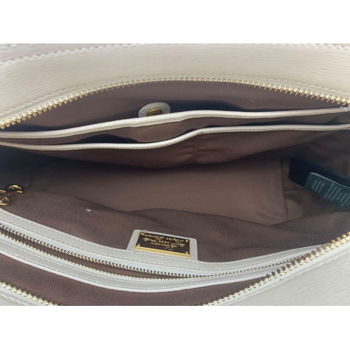 2 - A Ralph Lauren Cream Leather Handbag. Two exterior flaps. Zipped inner compartment. 36cm width. 26cm... 