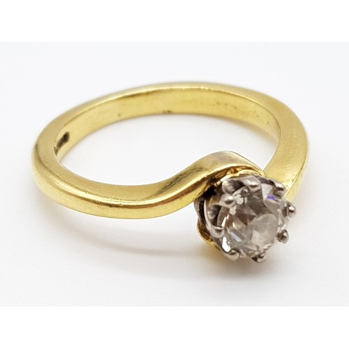 137 - An 18K Yellow Gold Diamond Solitaire Ring. Brilliant round cut diamond -0.5ct approx. Crossover styl... 