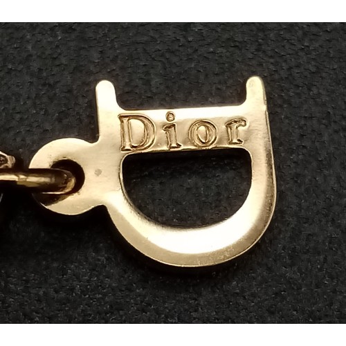 131 - A Christian Dior Gilded Tag Bracelet. Excellent condition. Comes in a Dior box. Ref: 11949