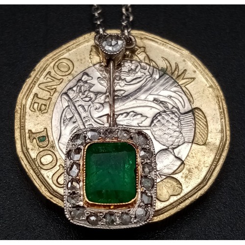 272 - An Emerald and Diamond Pendant on a Yellow Metal Chain. Rectangular emerald with a diamond surround ... 