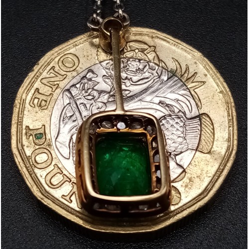 272 - An Emerald and Diamond Pendant on a Yellow Metal Chain. Rectangular emerald with a diamond surround ... 