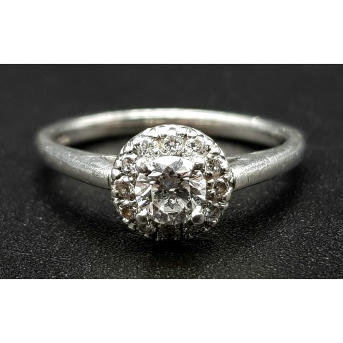 110 - An 18K White Gold and Diamond Ring. 0.25ct brilliant round cut central diamond (approx) surrounded b... 