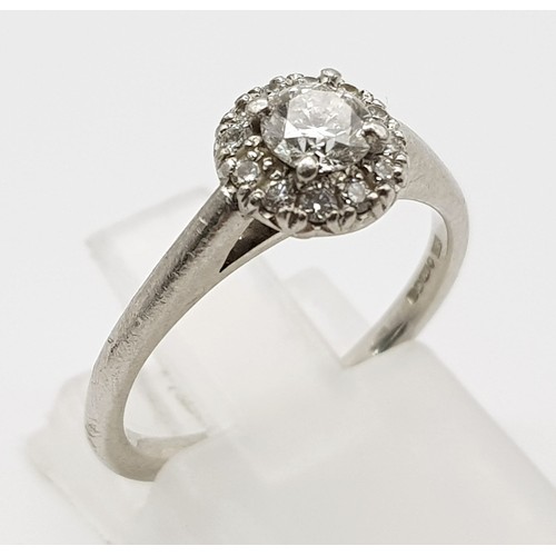 110 - An 18K White Gold and Diamond Ring. 0.25ct brilliant round cut central diamond (approx) surrounded b... 