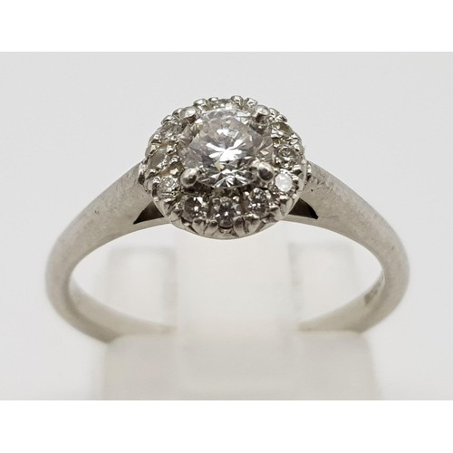 110 - An 18K White Gold and Diamond Ring. 0.25ct brilliant round cut central diamond (approx) surrounded b... 