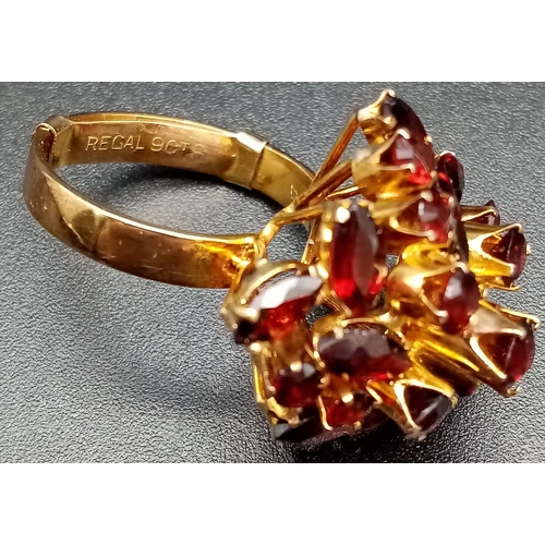 105 - A spectacular, 14 K yellow gold ring, profusely encrusted with twenty four, high quality garnets of ... 