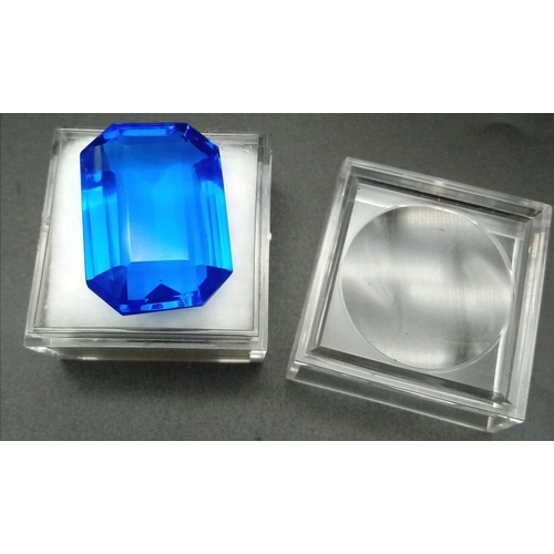 147 - A mouth-watering, huge (90.15 carats) TANZANITE. Emerald cut, lab created, flawless, in perfect cond... 