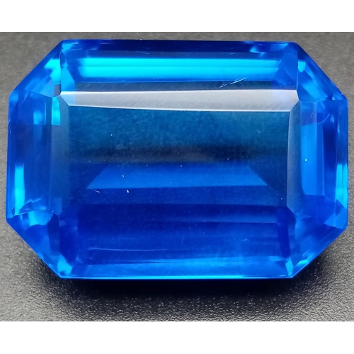 147 - A mouth-watering, huge (90.15 carats) TANZANITE. Emerald cut, lab created, flawless, in perfect cond... 