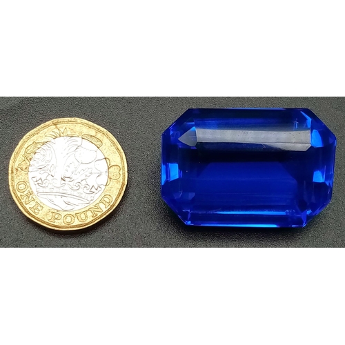 147 - A mouth-watering, huge (90.15 carats) TANZANITE. Emerald cut, lab created, flawless, in perfect cond... 