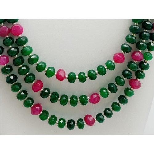 161 - A very feminine, three row necklace and earrings set with multifaceted emeralds and rubies. Necklace... 