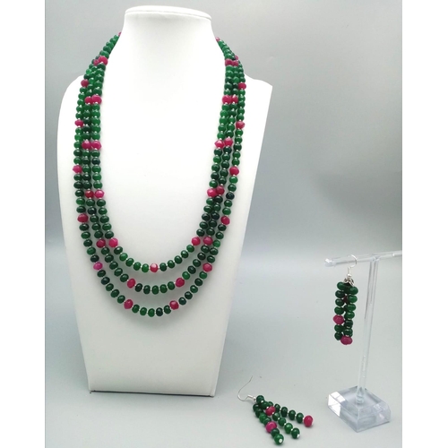 161 - A very feminine, three row necklace and earrings set with multifaceted emeralds and rubies. Necklace... 