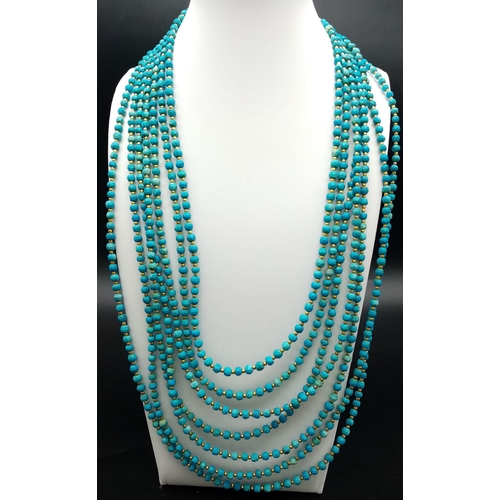 189 - A Turquoise coloured, seven row necklace in Ancient Egyptian Revival fashion. Length: 47-62 cm with ... 