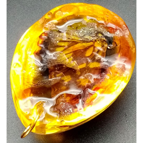 238 - Two large resin amber pendants with a butterfly inclusion. App 6 cm long.