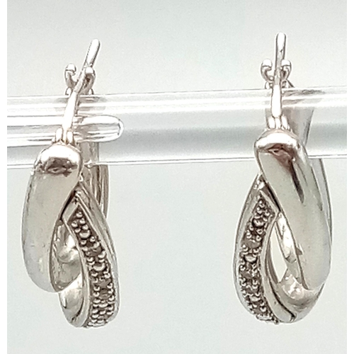 24 - A Fashionable Pair of 9K White Gold and Diamond Double-Hoop Earrings. 2.62g total weight.