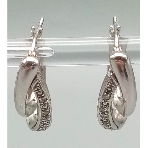 24 - A Fashionable Pair of 9K White Gold and Diamond Double-Hoop Earrings. 2.62g total weight.