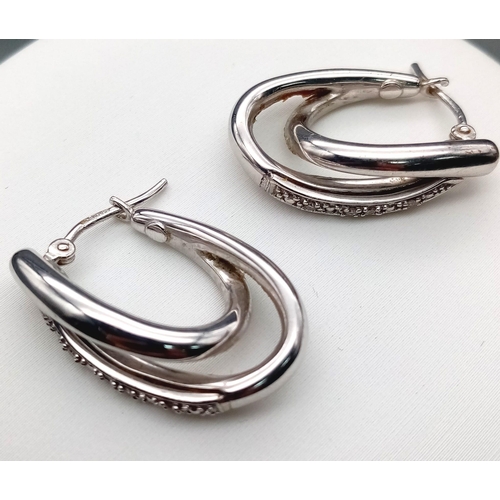 24 - A Fashionable Pair of 9K White Gold and Diamond Double-Hoop Earrings. 2.62g total weight.