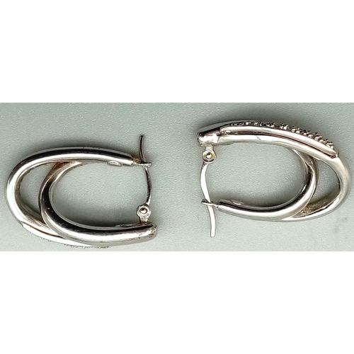 24 - A Fashionable Pair of 9K White Gold and Diamond Double-Hoop Earrings. 2.62g total weight.