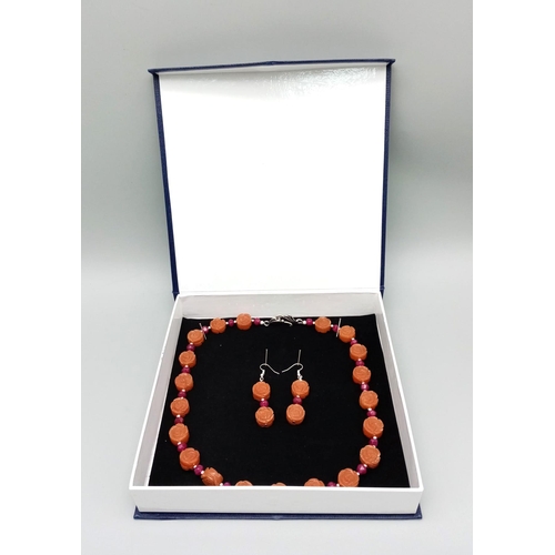 210 - A highly unusual carnelian and ruby necklace and earrings set. Hand carved, rose shaped, carnelian b... 