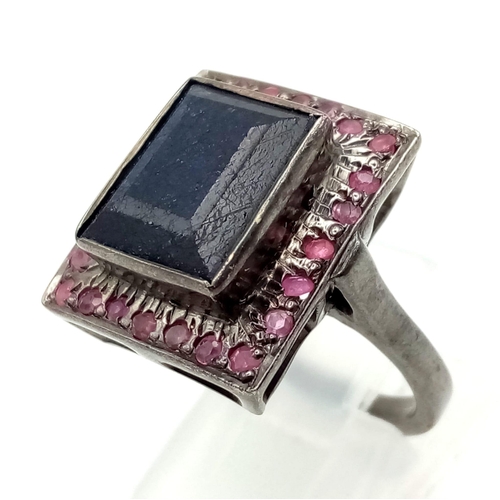 525 - A Blue Sapphire Ring set with Rubies. Rectangular step cut Sapphire. Set In Oxidised 925 Sterling si... 