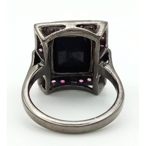 525 - A Blue Sapphire Ring set with Rubies. Rectangular step cut Sapphire. Set In Oxidised 925 Sterling si... 