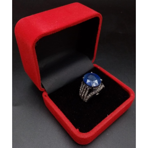 628 - An 8.70ct Blue Sapphire Ring - with 1.55ct of Diamond Accents. Set in 925 Silver. Size M. 7.3g total... 