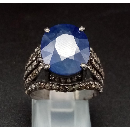 628 - An 8.70ct Blue Sapphire Ring - with 1.55ct of Diamond Accents. Set in 925 Silver. Size M. 7.3g total... 