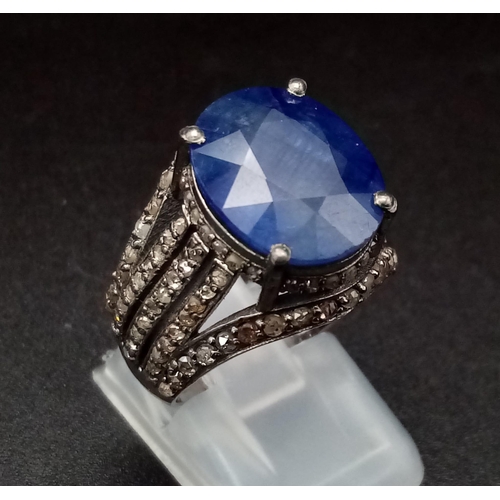 628 - An 8.70ct Blue Sapphire Ring - with 1.55ct of Diamond Accents. Set in 925 Silver. Size M. 7.3g total... 